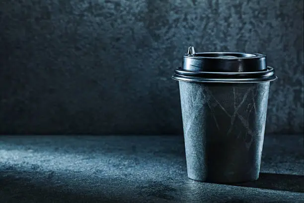 black coffee papercup on dark background