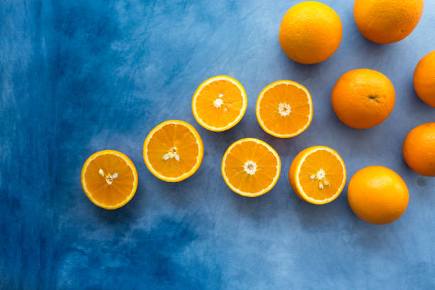 istock Set of fresh whole and cut orangeon blue background. From top view 1263338919