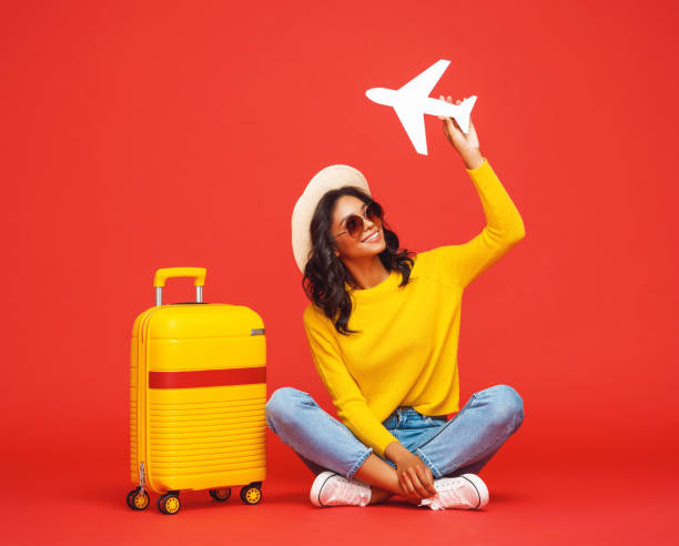 istock Positive ethnic tourist with toy plane 1263340400