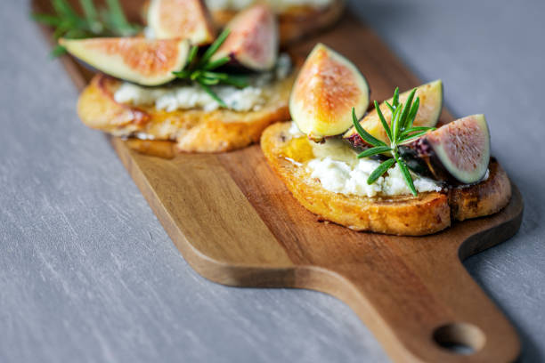 istock Sandwiches with fresh figs, blue cheese, rosemary and honey on cutting board 1263340407