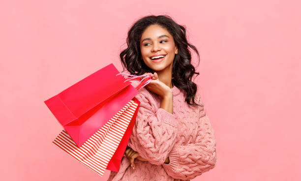 Friendly ethnic shopper with paper bags