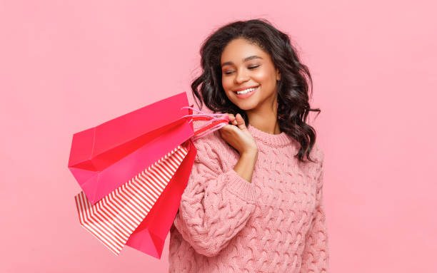 istock Friendly ethnic shopper with paper bags 1263341437