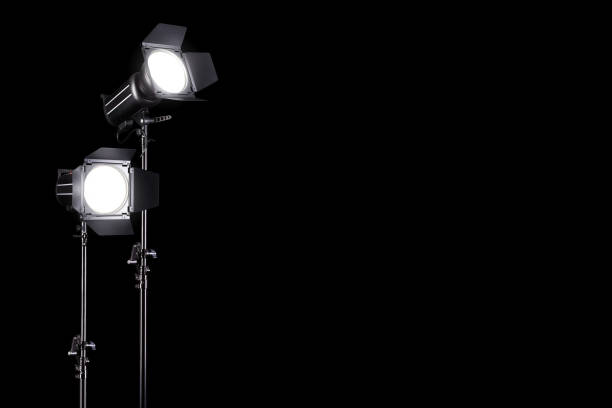 istock Photography studio flash on a lighting stand isolated on black background. 1263341632