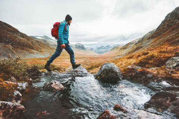 man solo traveling backpacker hiking in scandinavian mountains active healthy lifestyle adventure journey vacations - roupa de esportes imagens e fotografias de stock