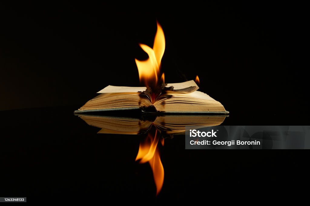 Burning book isolated on black background and reflective surface. Concept photography about literature, art, anti-utopia Burning book isolated on black background and reflective surface. Concept photography about literature, art, anti-utopia. High quality photo Fire - Natural Phenomenon Stock Photo