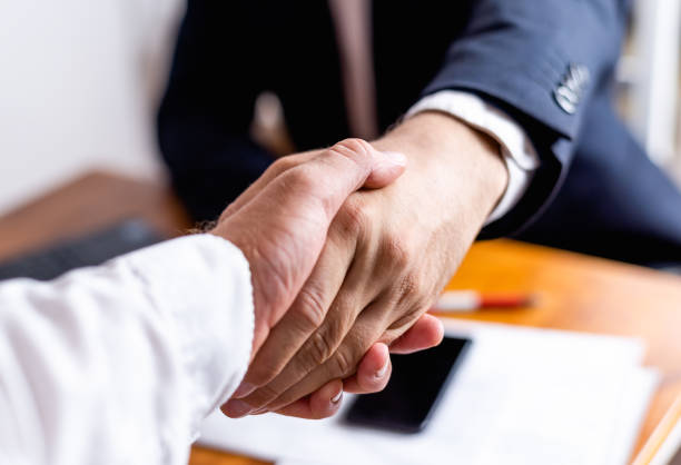 istock Businessman handshake close up. 1263350501