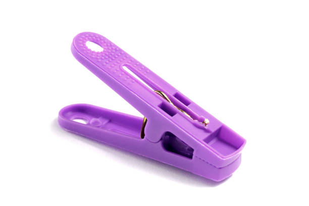 Purple clothespin close-up on white background, isolate.