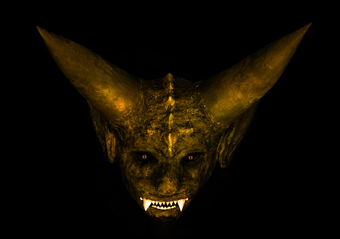 Devil on a black background. Scary Halloween mask. The concept of a frightening form of evil spirits