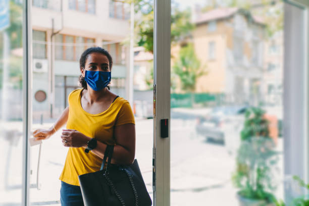 bizneswoman z maską ochronną podczas covid-19 - come in were open zdjęcia i obrazy z banku zdjęć