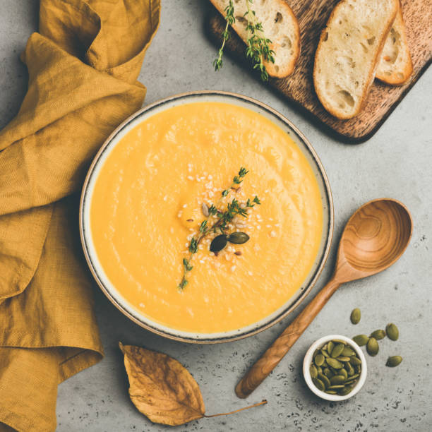 istock Pumpkin cream soup on concrete background 1263353214