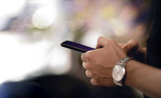 istock Man Using Mobile Phone. Closeup shot. plenty of Copy Space 1263353297