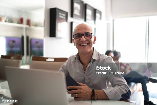 Portrait Of A Mature Man Working From Home Stock Photo - Download Image Now - Men, Businessman, Gay Man