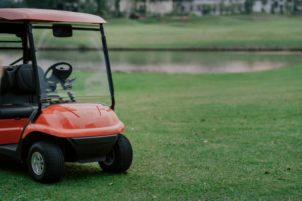 istock a red golf cart in the golf course during sunset 1263353893