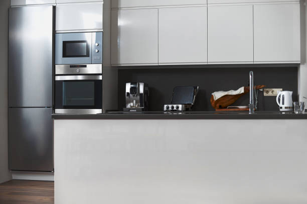 istock Modern white kitchen, minimalist interior with sunlight in daytime. Full set of kitchen equipment 1263354268