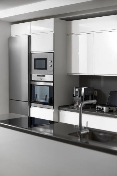 istock Modern white kitchen, minimalist interior with sunlight in daytime. Full set of kitchen equipment 1263354271