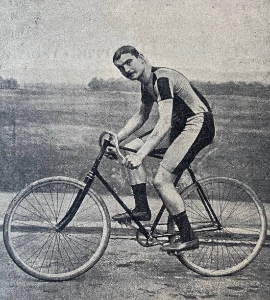 istock Cyclist Artur Linton on the road, side view, looking at the viewer 1263355364