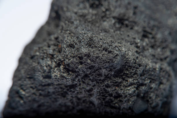 istock Blurred black background in soft focus with hard coal at high magnification. An image on the theme of geology and the extraction of minerals and natural fuels. 1263357471