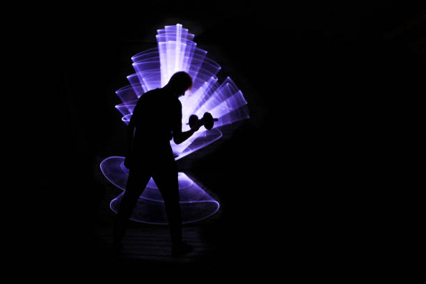 istock Silhouette of a man using dumbbells. 1263359877