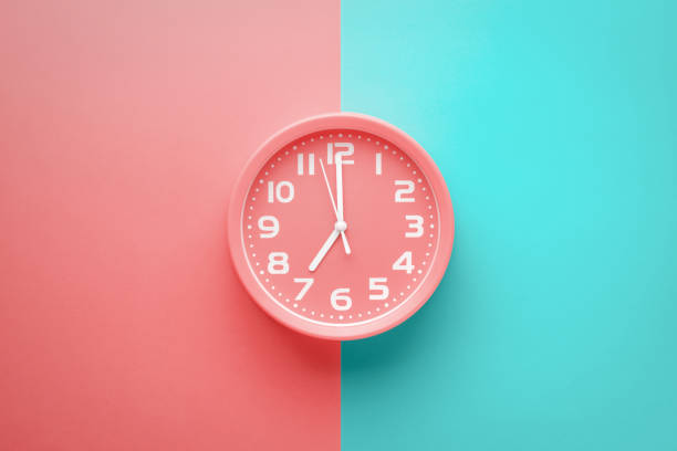 istock Top view red clock alarm clock not colored background divided vertically into red and green color 1263360002