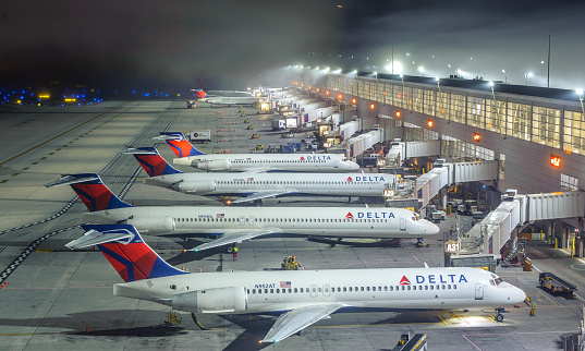 Detroit, MI, USA, Sep. 15, 2017: Several Delta Air Lines B717 airplanes at DTW airport, in a foggy night