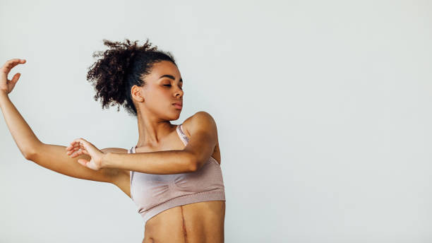 istock Young woman practicing dancing moves with hands in the studio 1263363399