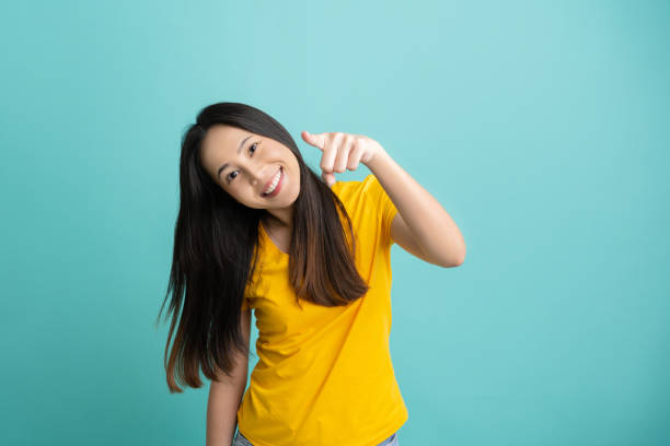 istock Asian woman. She is pointing in front needs.She smiled 1263363414