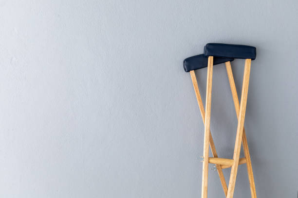 istock closeup pair wooden crutches on gray background 1263363514