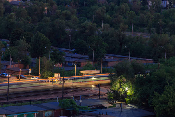 istock Railway crossing with a long exposure train at night 1263364387
