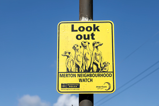 August 2nd 2020. Mitcham, Merton, London. Meerkats are well known for keeping watch, a trait used in this yellow sign notifying street visitors that a Neighbourhood Watch scheme is in operation here in Mitcham, Surrey, England.