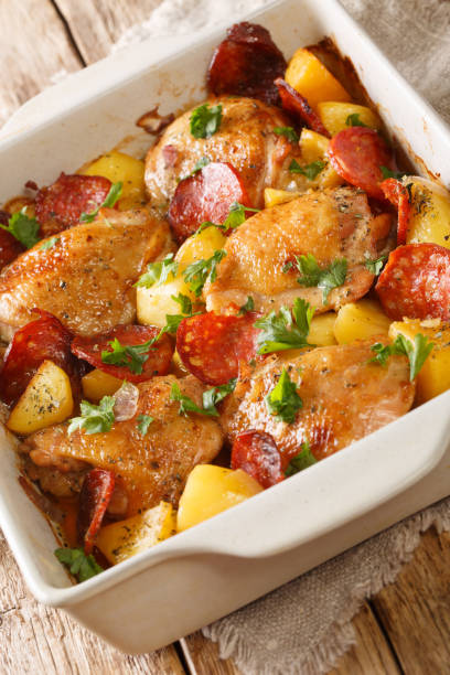 istock Spanish chicken with potatoes and chorizo close-up in a baking dish. vertical 1263374486