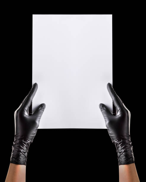istock Hand in black gloves holding blank cardboard isolated on black 1263374789