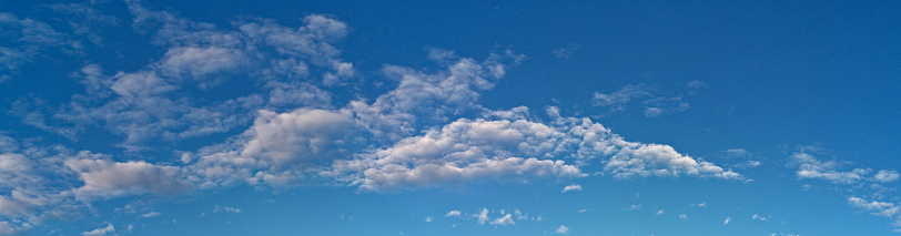 Mixed types of clouds combine in a deep blue sky to give a feeling of awe in the viewer.