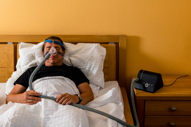 istock man sleeping with cpap mask because of obstructive sleep apnea 1263376839