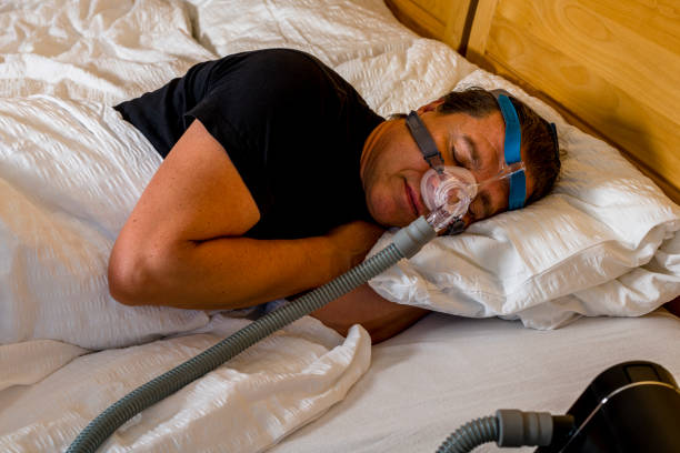 istock man sleeping with cpap mask because of obstructive sleep apnea 1263377012