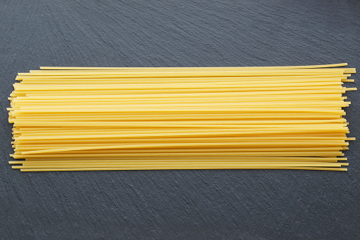 Spaghetti on a slate background.