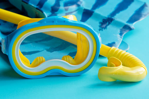 istock Snorkeling mask and fins on blue background. 1263377055