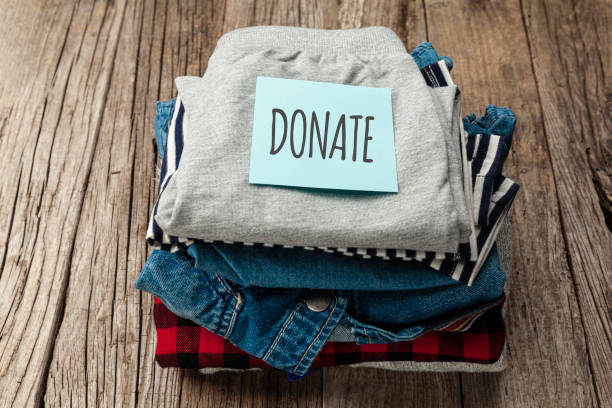 istock Stack of old clothes to discard (declutter) or donate. Recycling fabric cotton 1263379498