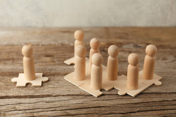 istock Wooden figures on puzzles. People analytics and optimization, team building. Group connection in business 1263379577