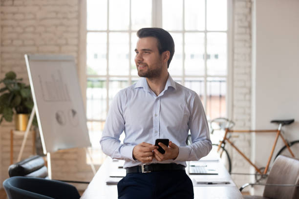 istock Smiling Caucasian businessman look in distance dreaming 1263380021