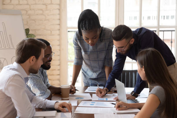 istock Multiethnic employees talk cooperating at business briefing 1263380504