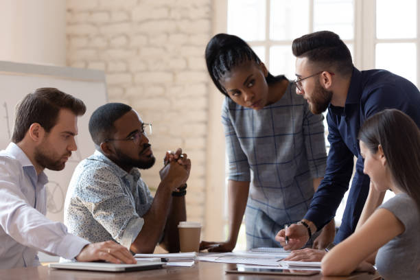 istock Diverse millennial employees discuss business project at meeting 1263380509