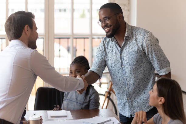 istock Smiling diverse colleagues handshake getting acquainted at meeting 1263380514
