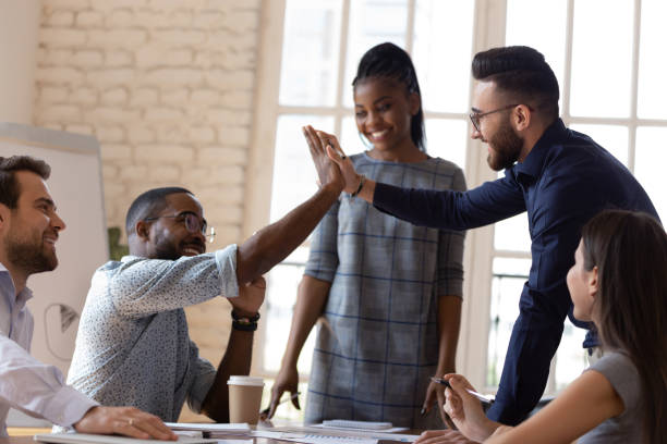 istock Excited diverse male employees give high five at briefing 1263380515