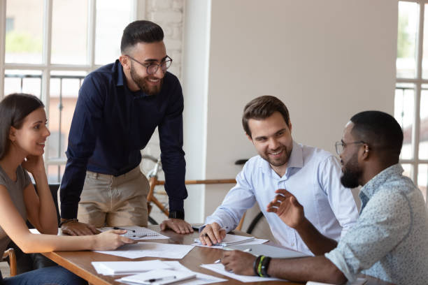 istock Smiling multiethnic employees brainstorm at office meeting 1263380529