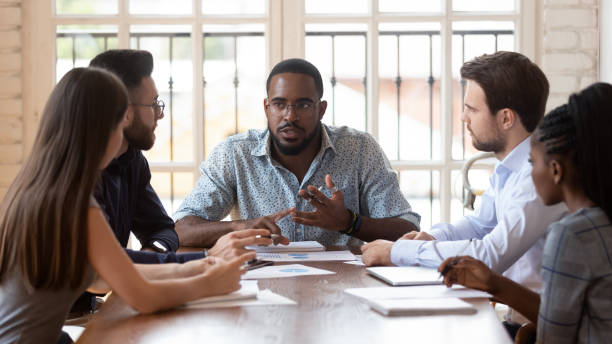 istock Multinational millennial colleagues gather at office meeting 1263380532