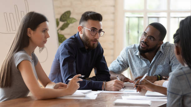 istock Diverse millennial colleagues brainstorm at team meeting 1263380544