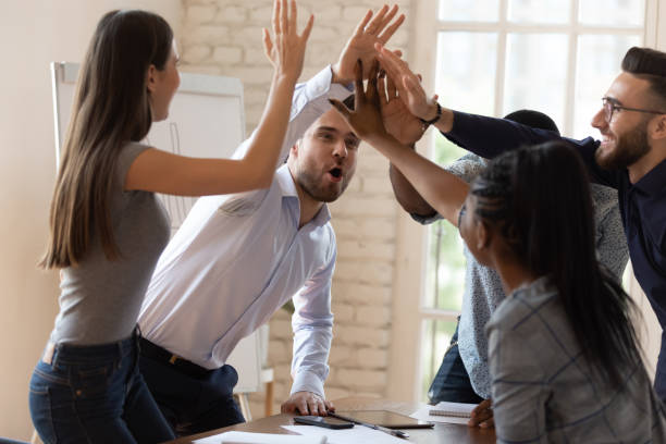 istock Overjoyed diverse employees give high five celebrating success 1263380554