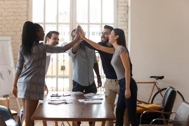 istock Happy multiethnic colleagues involved in teambuilding activity in office 1263380559