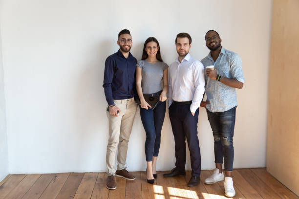 istock Portrait of smiling diverse employees posing together 1263380561