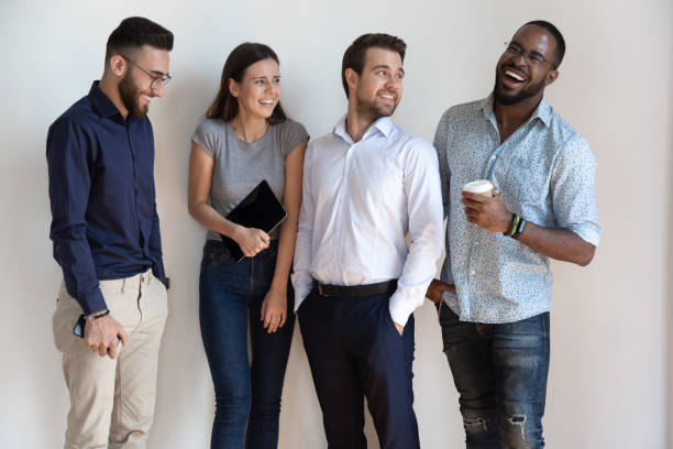 istock Overjoyed multiethnic millennial employees laugh posing together 1263380570
